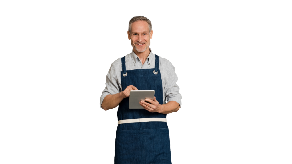 smiling grey-haired male in blue apron holding tablet